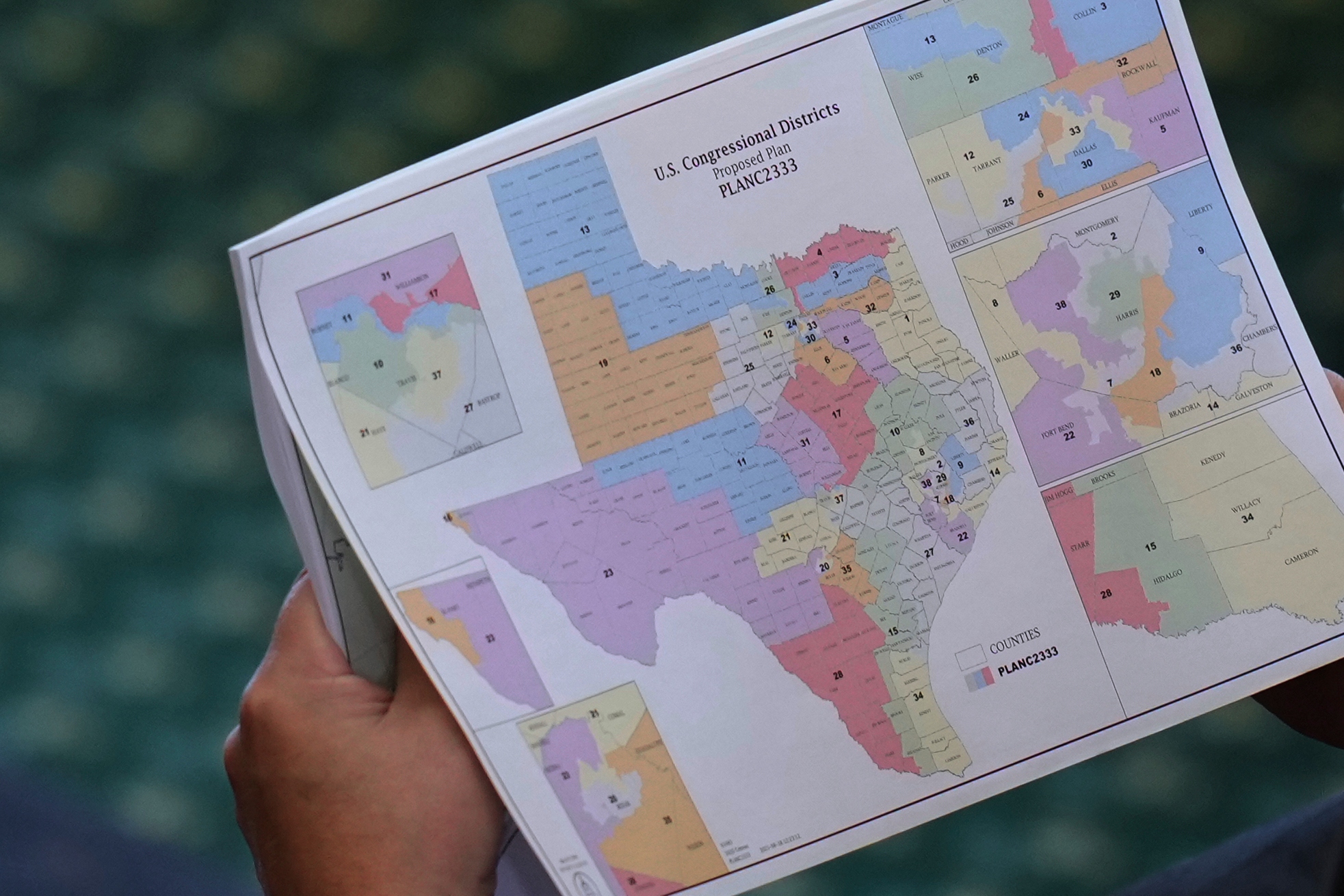 A Texas lawmaker looks over a redistricting map during the debate in the state senate in August.